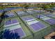 Aerial view of multiple pickleball courts with players, nets, and green surrounding areas at 6519 Grand Estuary Trl # 101, Bradenton, FL 34212