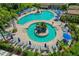 Aerial shot displays the resort-style community pool with lounge seating and tropical landscaping at 6519 Grand Estuary Trl # 101, Bradenton, FL 34212