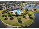 Aerial view of community pool, sun loungers, palm trees and clubhouse at 6519 Grand Estuary Trl # 101, Bradenton, FL 34212