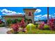 Clubhouse at the tennis center with colorful landscaping and oversized tennis ball at 6519 Grand Estuary Trl # 101, Bradenton, FL 34212