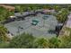 Aerial shot displays the community tennis courts with shaded benches and landscaping at 6519 Grand Estuary Trl # 101, Bradenton, FL 34212