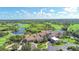Aerial view of a clubhouse with surrounding homes, green golf course and lakes at 6621 The Masters Ave, Lakewood Ranch, FL 34202