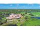 Aerial view of clubhouse and its surroundings, including homes, golf course and lakes at 6621 The Masters Ave, Lakewood Ranch, FL 34202