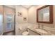 Cozy bathroom features a granite countertop, tiled floors, wainscoting, and a door to the exterior at 6621 The Masters Ave, Lakewood Ranch, FL 34202
