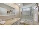 Neutral bathroom featuring tiled floors, a shower-tub combo with glass door, and a white vanity at 6621 The Masters Ave, Lakewood Ranch, FL 34202