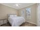 The bedroom features wood-look floors, a white ceiling fan, and plantation shutters on the bright windows at 6621 The Masters Ave, Lakewood Ranch, FL 34202