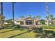 Beautiful clubhouse with stone pillars, manicured lawn, and tropical palm trees at 6621 The Masters Ave, Lakewood Ranch, FL 34202