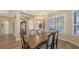 Beautiful dining room with hardwood floors, bright windows, and decorative chandelier at 6621 The Masters Ave, Lakewood Ranch, FL 34202