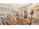 Elegant dining room with a large table, decorative chandelier, and views into the living area at 6621 The Masters Ave, Lakewood Ranch, FL 34202