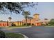 Beautiful exterior of a Mediterranean-style clubhouse featuring a grand entrance, lush landscaping, and inviting architecture at 6621 The Masters Ave, Lakewood Ranch, FL 34202