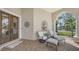 Inviting front porch with brick flooring, comfortable seating, and a charming water feature at 6621 The Masters Ave, Lakewood Ranch, FL 34202