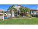 Charming home with well-manicured front lawn and beautiful tropical landscaping at 6621 The Masters Ave, Lakewood Ranch, FL 34202