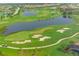 Scenic aerial view of a meticulously maintained golf course with lush green fairways, serene water features, and manicured greens at 6621 The Masters Ave, Lakewood Ranch, FL 34202
