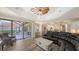 Spacious living room with comfortable seating, hardwood floors, and views of the pool area at 6621 The Masters Ave, Lakewood Ranch, FL 34202