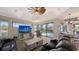 Comfortable living room with large sliding glass doors, views of the pool, and comfortable furniture at 6621 The Masters Ave, Lakewood Ranch, FL 34202