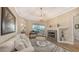 Cozy living room with a fireplace, comfortable seating, and lots of natural light at 6621 The Masters Ave, Lakewood Ranch, FL 34202