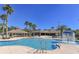 Resort-style pool area featuring a sparkling pool, comfortable lounge chairs, and lush tropical landscaping at 6621 The Masters Ave, Lakewood Ranch, FL 34202