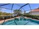 A geometric swimming pool with a tiered fountain is surrounded by screens to keep out bugs at 6621 The Masters Ave, Lakewood Ranch, FL 34202