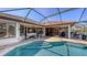 Back of house shows pool and large patio with shade for entertaining at 6621 The Masters Ave, Lakewood Ranch, FL 34202