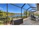 Charming screened patio overlooking a picturesque lake, ideal for al fresco dining and enjoying nature's tranquility at 6621 The Masters Ave, Lakewood Ranch, FL 34202