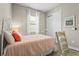 Bright bedroom featuring a white metal bed frame, accent pillow, a closet and decorative artwork at 7036 Whittlebury Trl, Lakewood Ranch, FL 34202