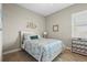 Cozy bedroom with light blue accents, decorative starfish and colorful, patterned bedding at 7036 Whittlebury Trl, Lakewood Ranch, FL 34202
