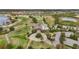 Aerial shot of the grand clubhouse with manicured lawns and lush landscaping at 7036 Whittlebury Trl, Lakewood Ranch, FL 34202