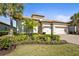 Beautiful home features a well-manicured lawn, tile roof, three-car garage and lush landscaping at 7036 Whittlebury Trl, Lakewood Ranch, FL 34202
