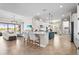 Open-concept kitchen featuring an island, stainless steel appliances, and seamless flow into the living area at 7036 Whittlebury Trl, Lakewood Ranch, FL 34202