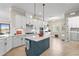 Bright kitchen featuring an island, stainless appliances, a window, and tiled flooring at 7036 Whittlebury Trl, Lakewood Ranch, FL 34202