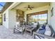 Outdoor kitchen and patio area with grill, seating, and scenic views of the lake at 7036 Whittlebury Trl, Lakewood Ranch, FL 34202