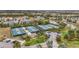 Aerial view of community pickleball courts with lush landscaping, parking, and beautiful surrounding homes at 7036 Whittlebury Trl, Lakewood Ranch, FL 34202