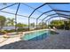 Screened-in pool and hot tub with beautiful lake view, patio area, and outdoor seating at 7036 Whittlebury Trl, Lakewood Ranch, FL 34202