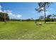 A spacious backyard featuring a fire pit area and lush green lawn provides a serene outdoor retreat at 7108 229Th E St, Bradenton, FL 34211