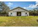 Spacious horse barn featuring sliding doors, windows and well maintained grassy surroundings at 7108 229Th E St, Bradenton, FL 34211