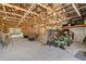 Spacious barn interior with wooden beams, open stalls, lighting, concrete floors, and a green tractor at 7108 229Th E St, Bradenton, FL 34211