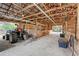 Spacious barn interior featuring ample lighting, wood framework, and equipment storage at 7108 229Th E St, Bradenton, FL 34211