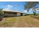 Exterior view of a well-maintained barn with a metal roof and grassy surroundings at 7108 229Th E St, Bradenton, FL 34211