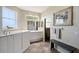 Bright bathroom featuring a large soaking tub, vanity, and tiled floors at 7108 229Th E St, Bradenton, FL 34211