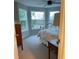Bright bedroom features a ceiling fan, three large windows, and neutral carpet at 7108 229Th E St, Bradenton, FL 34211