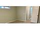 Simple bedroom featuring light walls and carpeting and a doorway to another room at 7108 229Th E St, Bradenton, FL 34211