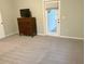 Bedroom features neutral carpet, a dresser, and a sliding glass door at 7108 229Th E St, Bradenton, FL 34211