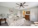 Spacious bedroom features a ceiling fan, ensuite bathroom, and neutral carpet at 7108 229Th E St, Bradenton, FL 34211