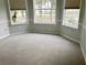 Empty bedroom features neutral carpet, crown molding, and large windows at 7108 229Th E St, Bradenton, FL 34211