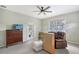 Bedroom featuring a ceiling fan, television, and access to an outdoor patio at 7108 229Th E St, Bradenton, FL 34211