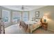 Light, airy bedroom with large windows, a ceiling fan, and a small writing desk at 7108 229Th E St, Bradenton, FL 34211