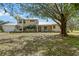 Charming two-story home with a metal roof, manicured landscaping, and a welcoming front porch at 7108 229Th E St, Bradenton, FL 34211