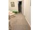 Hallway with floral chair, soft carpet, and doorway offering natural light at 7108 229Th E St, Bradenton, FL 34211