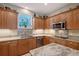 Updated kitchen featuring stainless steel appliances, granite countertops, tile backsplash, and ample cabinet space at 7108 229Th E St, Bradenton, FL 34211