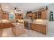 Spacious kitchen with tile floors, island and granite countertops and stainless steel appliances at 7108 229Th E St, Bradenton, FL 34211